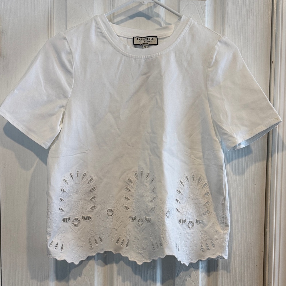 Bagatelle white Short Sleeved Top with cut out design. Size XS. NWT.